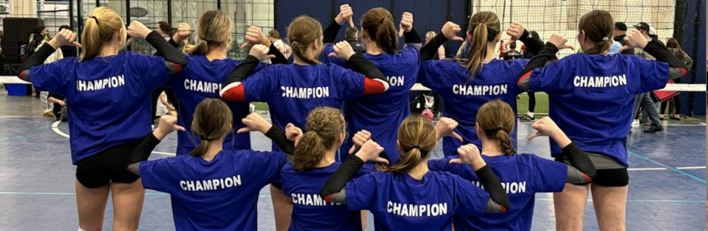 A group of young girls in blue shirts are doing the same pose.